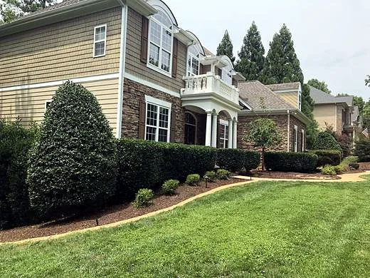 Sharply trimmed hedges and a clean-edged lawn after service
