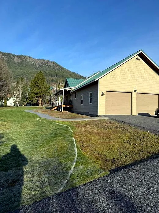 Lawn beside a garage marked out for a new landscape bed